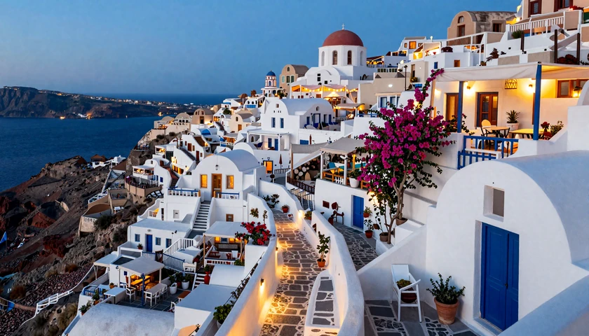 Charming Greek island village at dusk with warm taverna lights - romantic Greek dating atmosphere